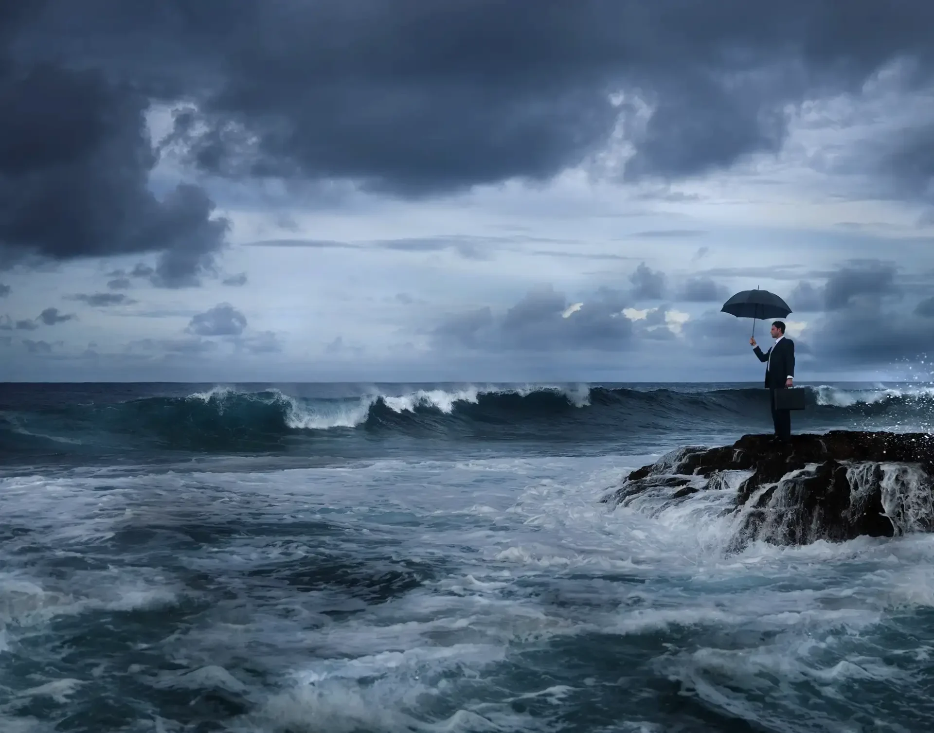 man with umbrella in ocean storm